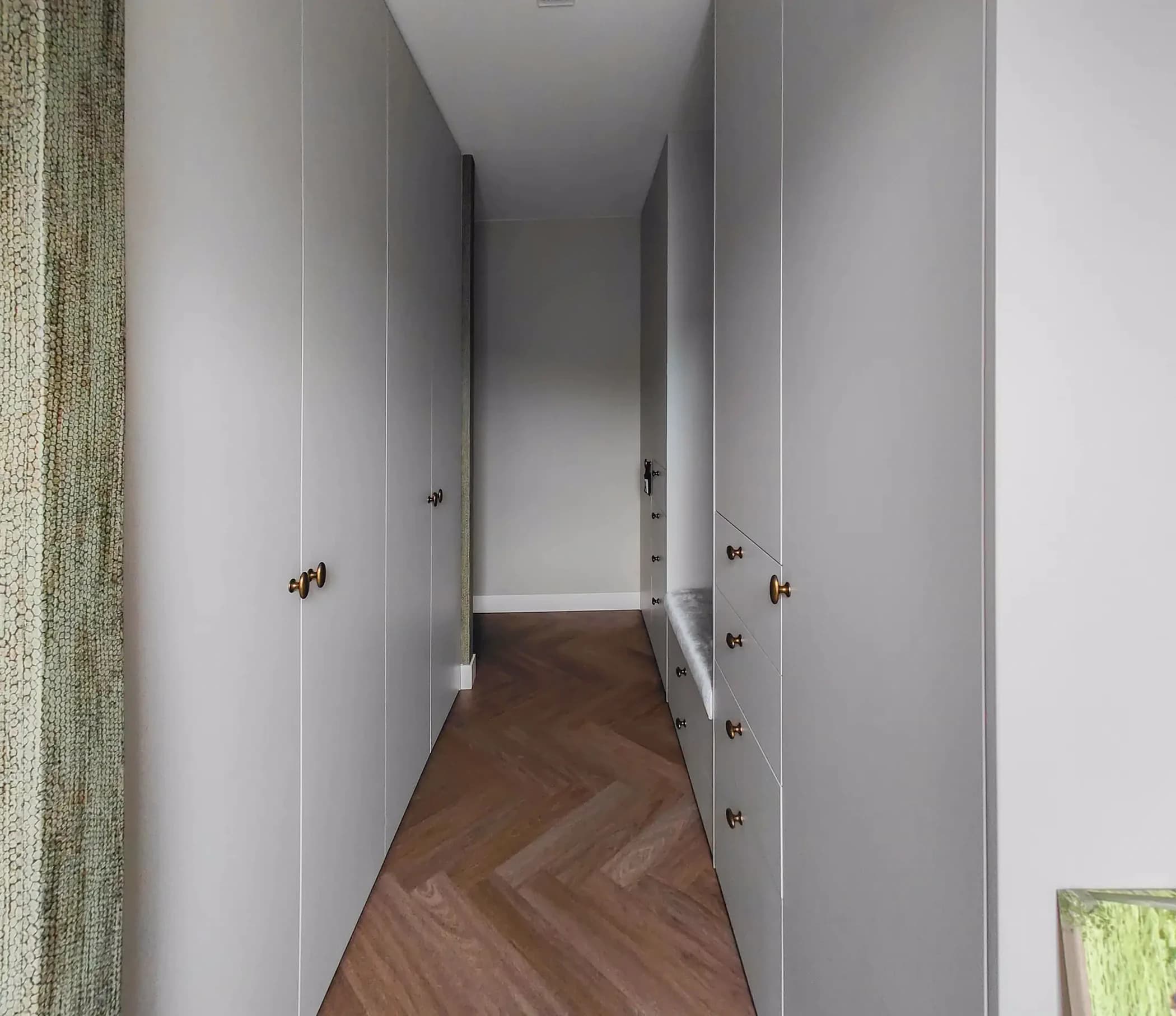 Detail van het zitgedeelte in een klassieke, chique inloopkast met opbergruimte in Barneveld.