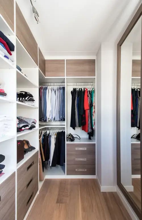 Inloopkast met grote spiegel en houtlook fronten